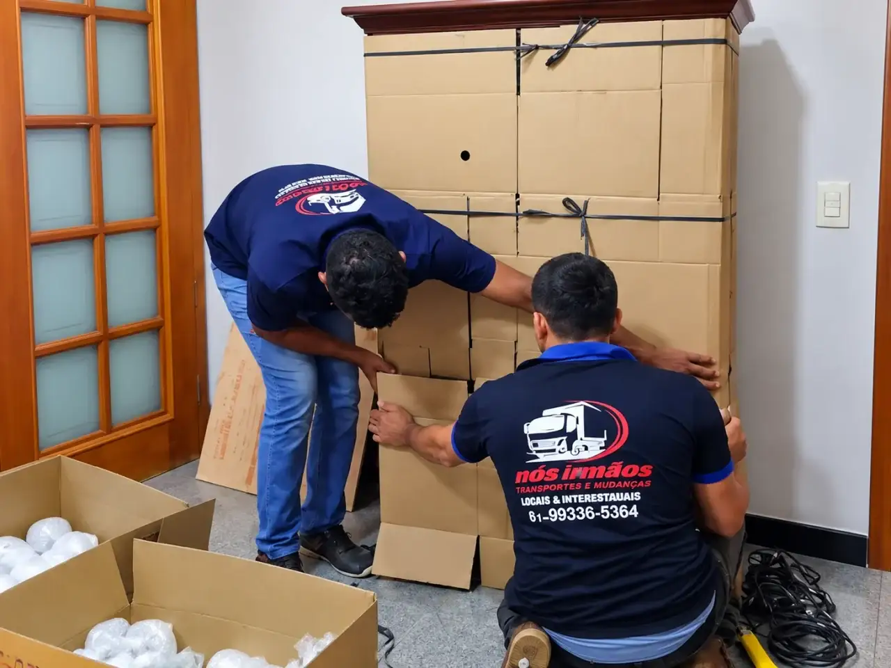 Equipe de empresa parceira movimentando um móvel embalado
